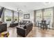 Spacious living room with stylish furniture, ceiling fan, and natural light streaming through large windows at 3430 Halsway Dr, Orlando, FL 32824