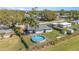 Aerial view of fenced in backyard with an above ground swimming pool and lawn at 395 Bearcreek Dr, Bartow, FL 33830