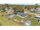 Aerial view of home with chain-link fence, above-ground pool, and lawn at 395 Bearcreek Dr, Bartow, FL 33830