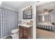 Well-lit bathroom with modern vanity and charming checkered shower curtain at 395 Bearcreek Dr, Bartow, FL 33830