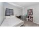 Serene bedroom featuring a canopy bed, desk area, dresser, and closet creating a cozy and organized space at 395 Bearcreek Dr, Bartow, FL 33830