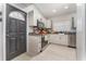 Modern kitchen featuring sleek white cabinets, stainless steel appliances, and tile floors at 395 Bearcreek Dr, Bartow, FL 33830