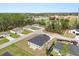 A bird's eye view shows the house with a dark roof in a residential area near a recreational field and green trees at 4016 Sw 151 Street, Ocala, FL 34473