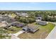 An aerial view of a house with a grey roof and siding in a neighborhood surrounded by trees and other houses at 4016 Sw 151 Street, Ocala, FL 34473