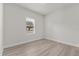 Cozy bedroom featuring light hardwood floors and natural light from a window at 4016 Sw 151 Street, Ocala, FL 34473