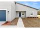 Inviting front entrance with a well-kept lawn and a blue door with sidelight windows at 4016 Sw 151 Street, Ocala, FL 34473