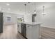 Open-concept kitchen island with a white countertop, stainless steel dishwasher, and modern pendant lighting at 4016 Sw 151 Street, Ocala, FL 34473