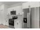 Modern kitchen with white cabinetry, stainless steel appliances including a refrigerator and a stove with microwave above at 4016 Sw 151 Street, Ocala, FL 34473