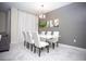 Chic dining room featuring a white table, stylish chairs, globe chandelier, and modern artwork at 432 Ocean Course Ave, Davenport, FL 33896