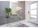 Tastefully decorated foyer with glass console table, modern lamps, statement mirror and white door at 432 Ocean Course Ave, Davenport, FL 33896