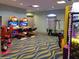 Fun game room featuring an air hockey table, arcade games, and wavy carpet at 432 Ocean Course Ave, Davenport, FL 33896