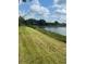 Green grassy lawn with gorgeous lake and dock views on a sunny day at 4501 Dallas Blvd, Orlando, FL 32833