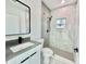 Modern bathroom with a sleek vanity, a black framed mirror, and a glass-enclosed shower with marble tile at 4501 Dallas Blvd, Orlando, FL 32833