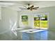 Bright bedroom with white walls, a ceiling fan, and a sliding glass door leading to the backyard at 4501 Dallas Blvd, Orlando, FL 32833