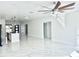 Spacious living room with white walls, tiled floors, and a modern ceiling fan at 4501 Dallas Blvd, Orlando, FL 32833