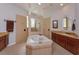 Luxurious bathroom featuring a corner tub, separate glass-enclosed shower, and granite countertops at 4963 Rock Rose Loop, Sanford, FL 32771