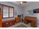 Spare bedroom features a shuttered window, exercise equipment, and a roll top desk at 4963 Rock Rose Loop, Sanford, FL 32771