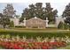 Well-maintained entrance sign to The Retreat at Wekiva community with lush landscaping and manicured hedges at 4963 Rock Rose Loop, Sanford, FL 32771