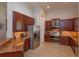 A kitchen featuring stainless steel appliances and dark wood cabinets at 4963 Rock Rose Loop, Sanford, FL 32771