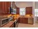 Modern kitchen with stainless steel appliances, granite counters, and decorative tile backsplash at 4963 Rock Rose Loop, Sanford, FL 32771