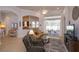 Bright living room with open floor plan, ceiling fan, and sliding glass doors to the patio at 4963 Rock Rose Loop, Sanford, FL 32771