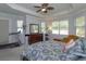 Primary bedroom with a ceiling fan, tray ceiling, and bright natural light at 4963 Rock Rose Loop, Sanford, FL 32771