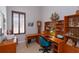 Bright home office with wooden shelves, corner desk, plantation shutters, and nautical decor at 4963 Rock Rose Loop, Sanford, FL 32771