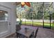 Inviting screened-in patio with brick flooring, ceiling fan, and outdoor dining set at 4963 Rock Rose Loop, Sanford, FL 32771