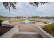 Serene lake view featuring a fountain, lush landscaping, and beautiful single Gathering homes at 4963 Rock Rose Loop, Sanford, FL 32771