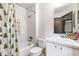 Clean bathroom with a shower-tub combo, white tile walls and a white vanity at 5042 Downing St # 5, Orlando, FL 32839