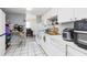 Functional kitchen with white appliances, tile floors, and ample counter space at 5042 Downing St # 5, Orlando, FL 32839