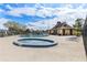 Community pool with sundeck, lounge chairs, blue tile hot tub, and pool house at 5042 Downing St # 5, Orlando, FL 32839