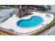 Community pool with blue water, sundeck, seating, mature trees, and pool house at 5042 Downing St # 5, Orlando, FL 32839