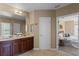 Bathroom featuring double vanity with granite counters, tiled floors, and bedroom view at 5189 Fenwood Ln, Orlando, FL 32814