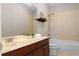 Bathroom featuring granite counters, under sink cabinet, and tiled shower at 5189 Fenwood Ln, Orlando, FL 32814