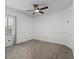 Bedroom featuring plush carpet, ceiling fan, and plantation shutters at 5189 Fenwood Ln, Orlando, FL 32814