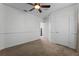 Bedroom featuring plush carpet, ceiling fan, and ensuite bathroom access at 5189 Fenwood Ln, Orlando, FL 32814