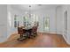 Stylish dining room with hardwood floors, modern lighting, and plenty of natural light at 5189 Fenwood Ln, Orlando, FL 32814