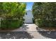 Wide driveway leading to a home with an attached garage and lush landscaping at 5189 Fenwood Ln, Orlando, FL 32814