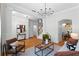 Bright living room featuring wood floors, modern chandelier, and staircase at 5189 Fenwood Ln, Orlando, FL 32814