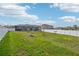 Spacious green backyard with views of neighboring homes and a screened in patio at 5269 Red Coral Cir, Mount Dora, FL 32757
