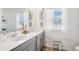 Bright bathroom featuring a double vanity with white quartz countertop and decor at 5269 Red Coral Cir, Mount Dora, FL 32757