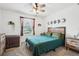 Cozy bedroom with window and rustic furniture, including a wooden headboard and nightstand at 5269 Red Coral Cir, Mount Dora, FL 32757