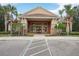 Exterior view of the clubhouse in a community with landscaping and handicap parking at 5269 Red Coral Cir, Mount Dora, FL 32757