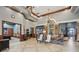 View of the clubhouse interior, decorated with chandeliers, furniture, and dark trim at 5269 Red Coral Cir, Mount Dora, FL 32757