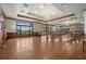 Spacious clubhouse event space with a wood floor, American flag, and large windows at 5269 Red Coral Cir, Mount Dora, FL 32757