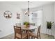 Cozy dining room with wood-look tile, a round table, decorative accents, and a window with natural light at 5269 Red Coral Cir, Mount Dora, FL 32757