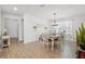 Inviting dining area with wood-look tile floors, decorative shelves, a pendant light, and a dining table at 5269 Red Coral Cir, Mount Dora, FL 32757