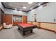 A game room featuring a pool table, seating, and storage cabinets, providing an ideal space for entertainment at 5269 Red Coral Cir, Mount Dora, FL 32757