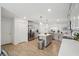Bright kitchen with island, stainless steel appliances, light gray cabinets, and wood-look tile flooring at 5269 Red Coral Cir, Mount Dora, FL 32757